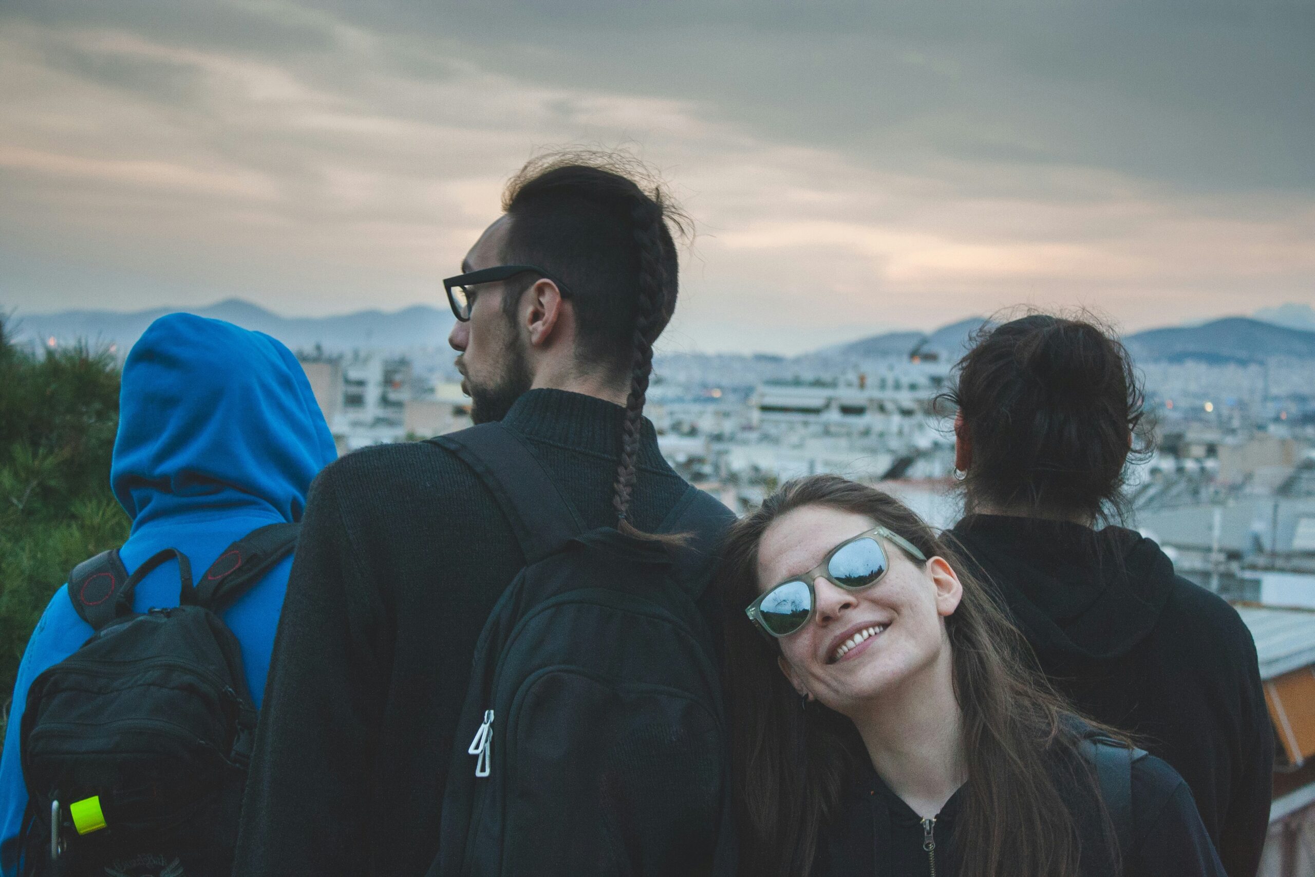 Friends taking picture with Athens city in the background